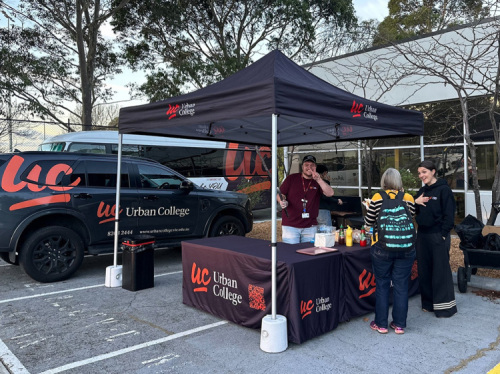 Urban College Open Night Sausage Sizzle with branded vehicle in background