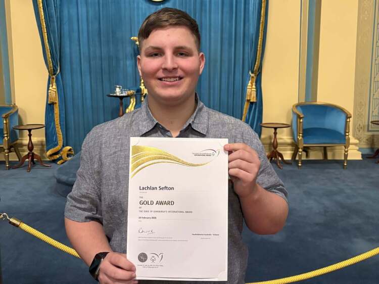 Lachlan holding his Gold Duke of Endinburgh Interantional Award