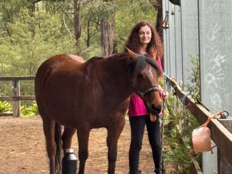 student enjoying some equine therapy with a pony