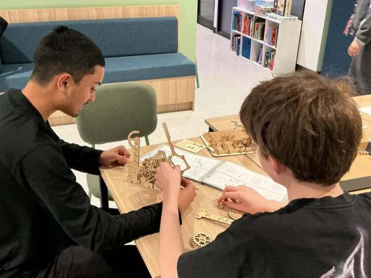 Urban College students working together on a hands-on construction activity