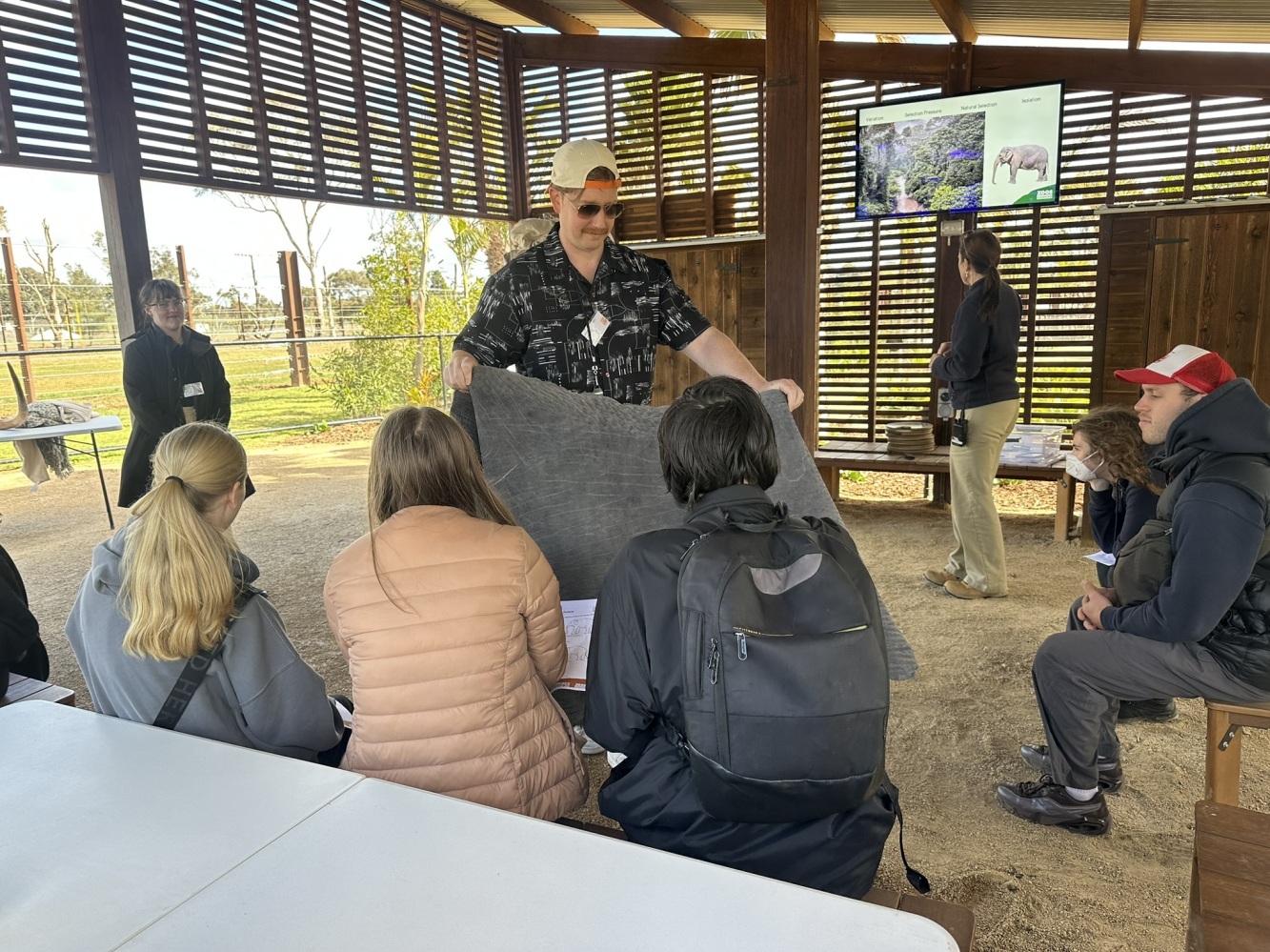 Zoo Keeper showing 3 students elephant skin during education talk