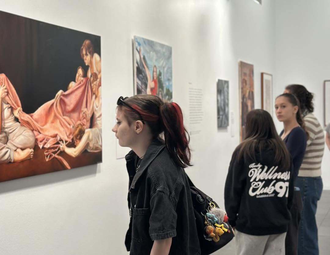 students looking at art on the wall