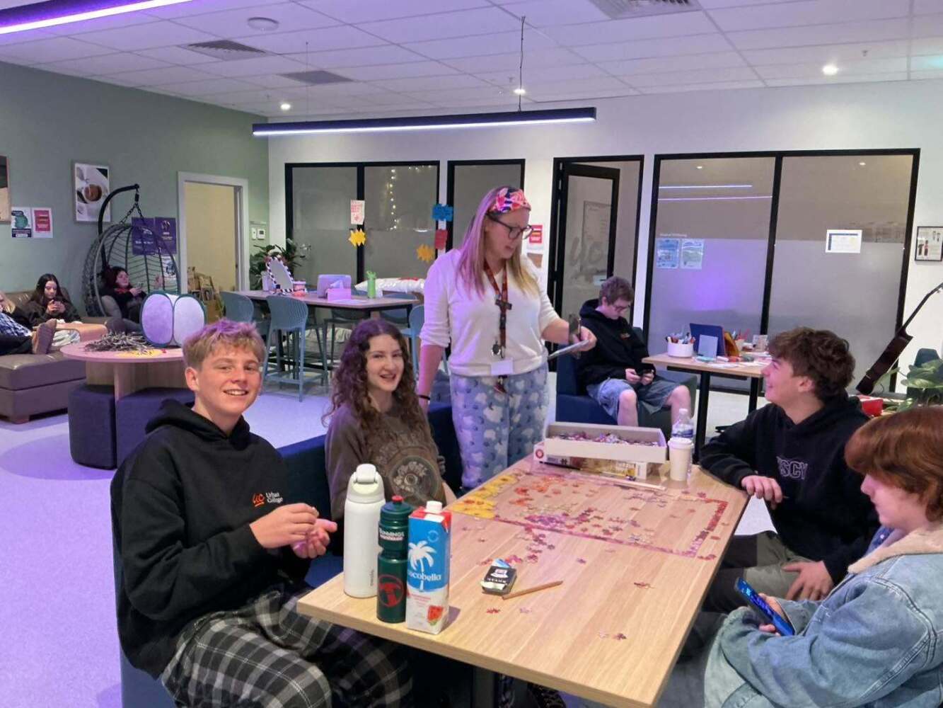 teacher and students doing a jigsaw puzzle