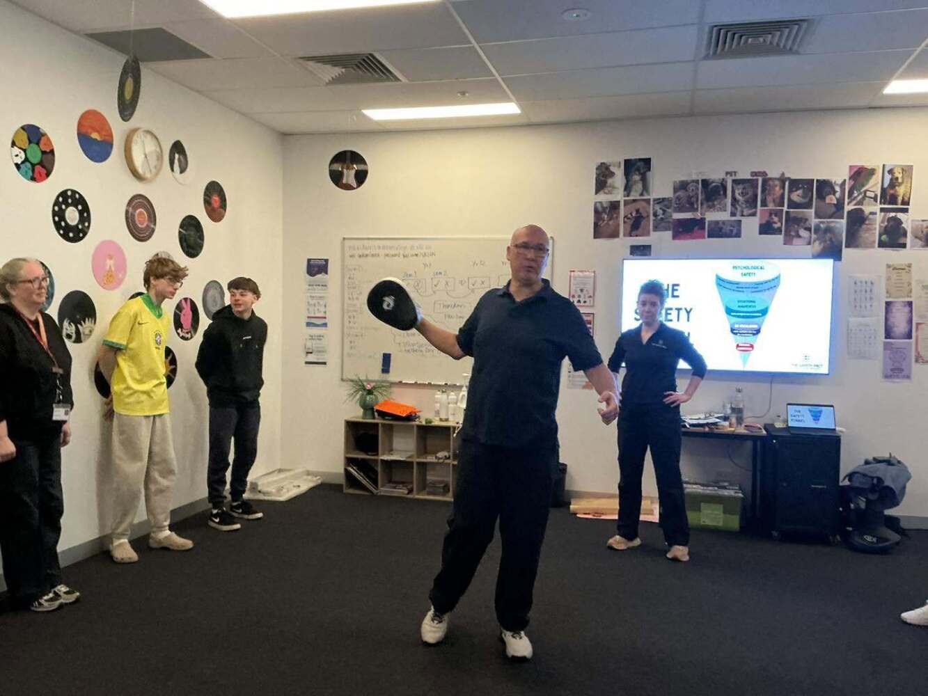 Male presenter demonstrating with pad on hand