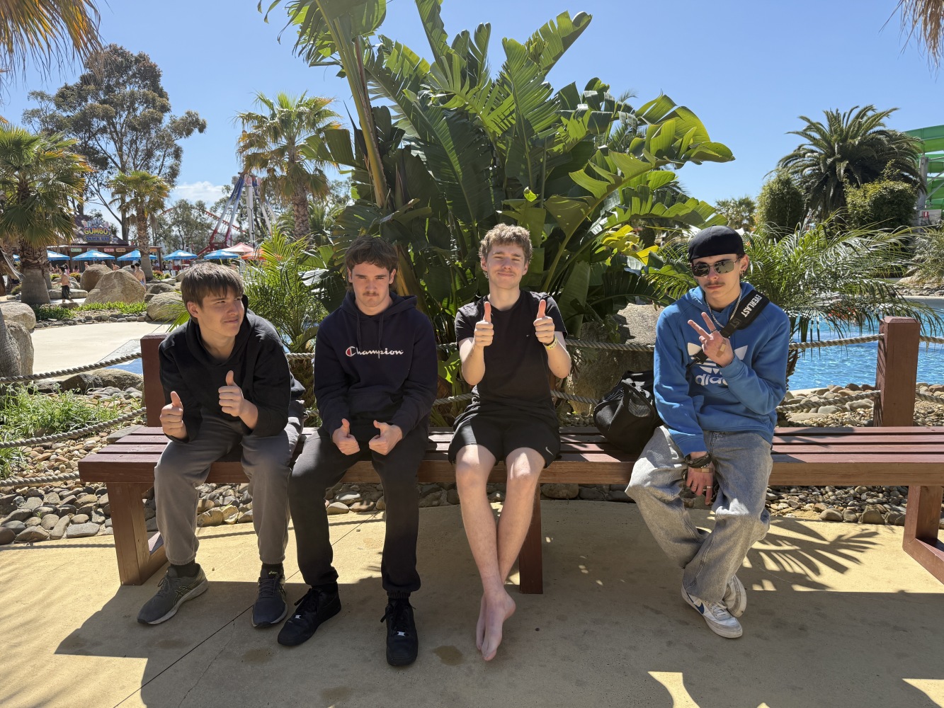 4 students sitting on bench