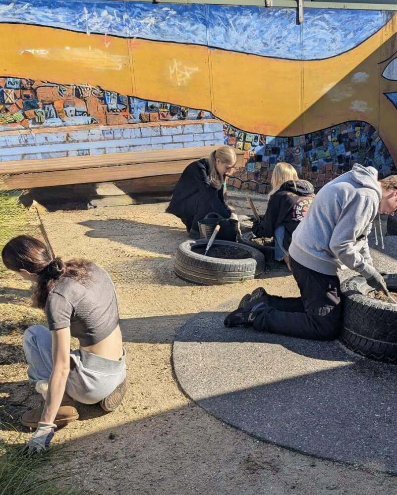 students planting in garden