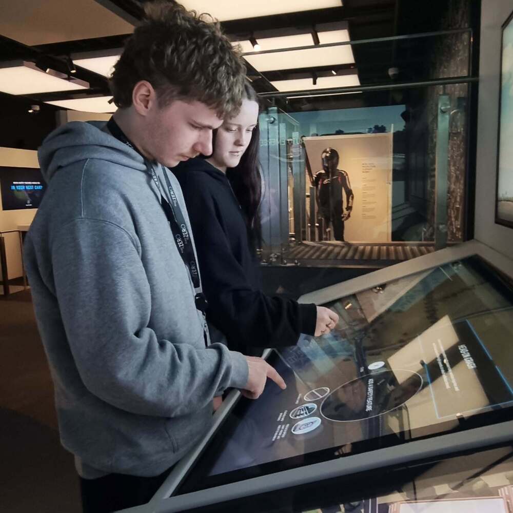 Year 12 students using an interactive touchscreen to learn about road safety