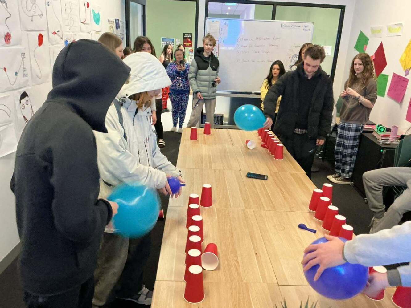 students playing games with red solo cups & balloons
