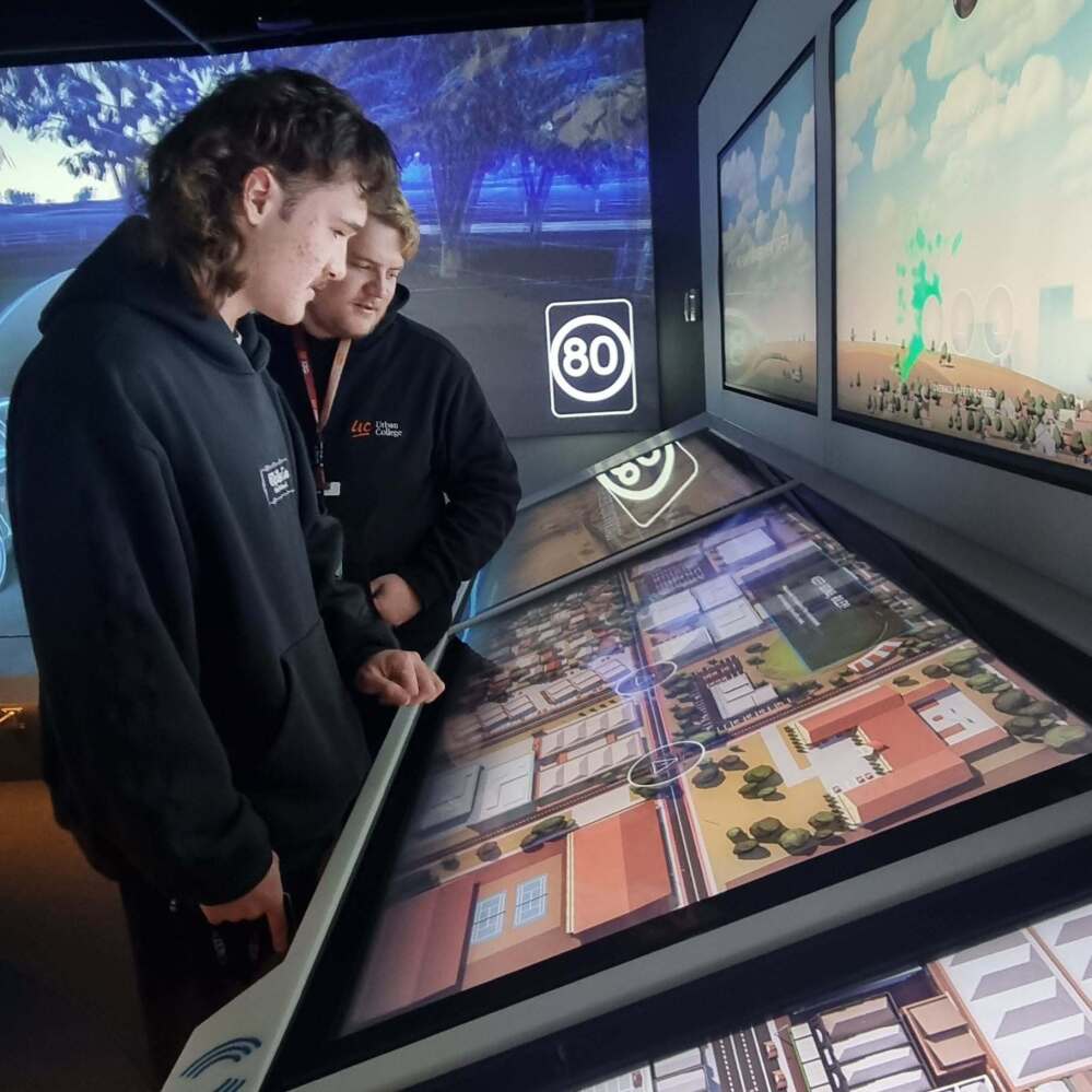 Urban College student exploring an interactive road safety and traffic conditions display