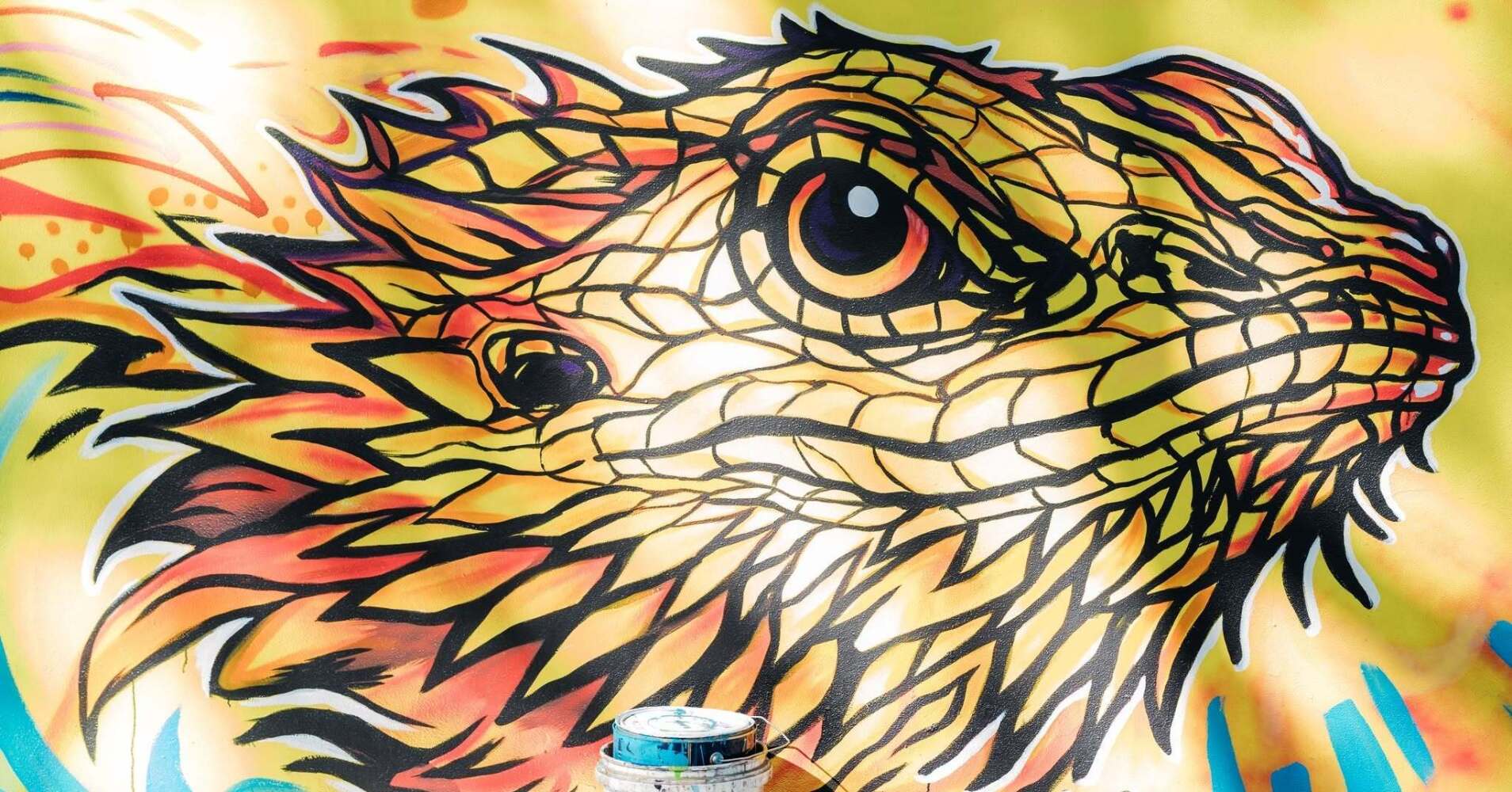 lizard face painted on wall as part of the mural