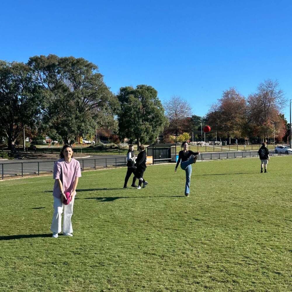 kicking the footy around on the oval
