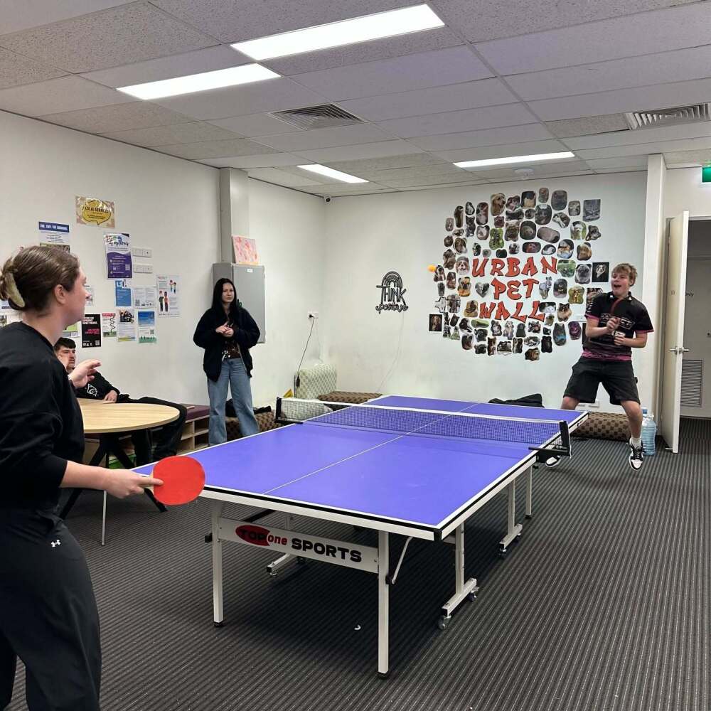 students enjoying a game of table tennis