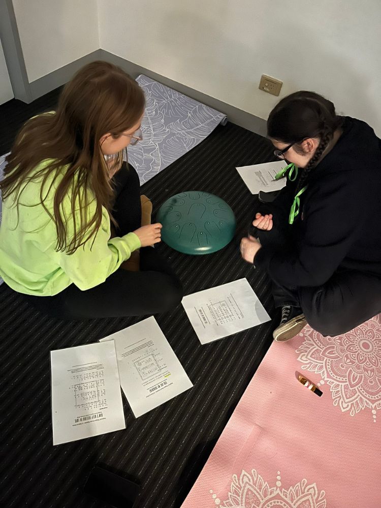 2 students meditation using tongue drum