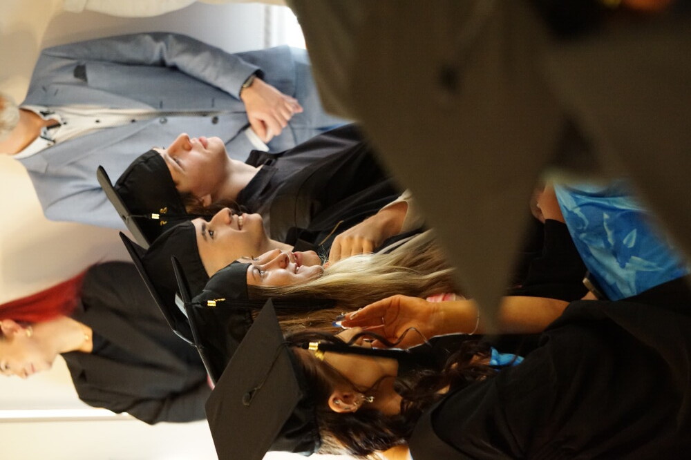 5 students gad hats sitting