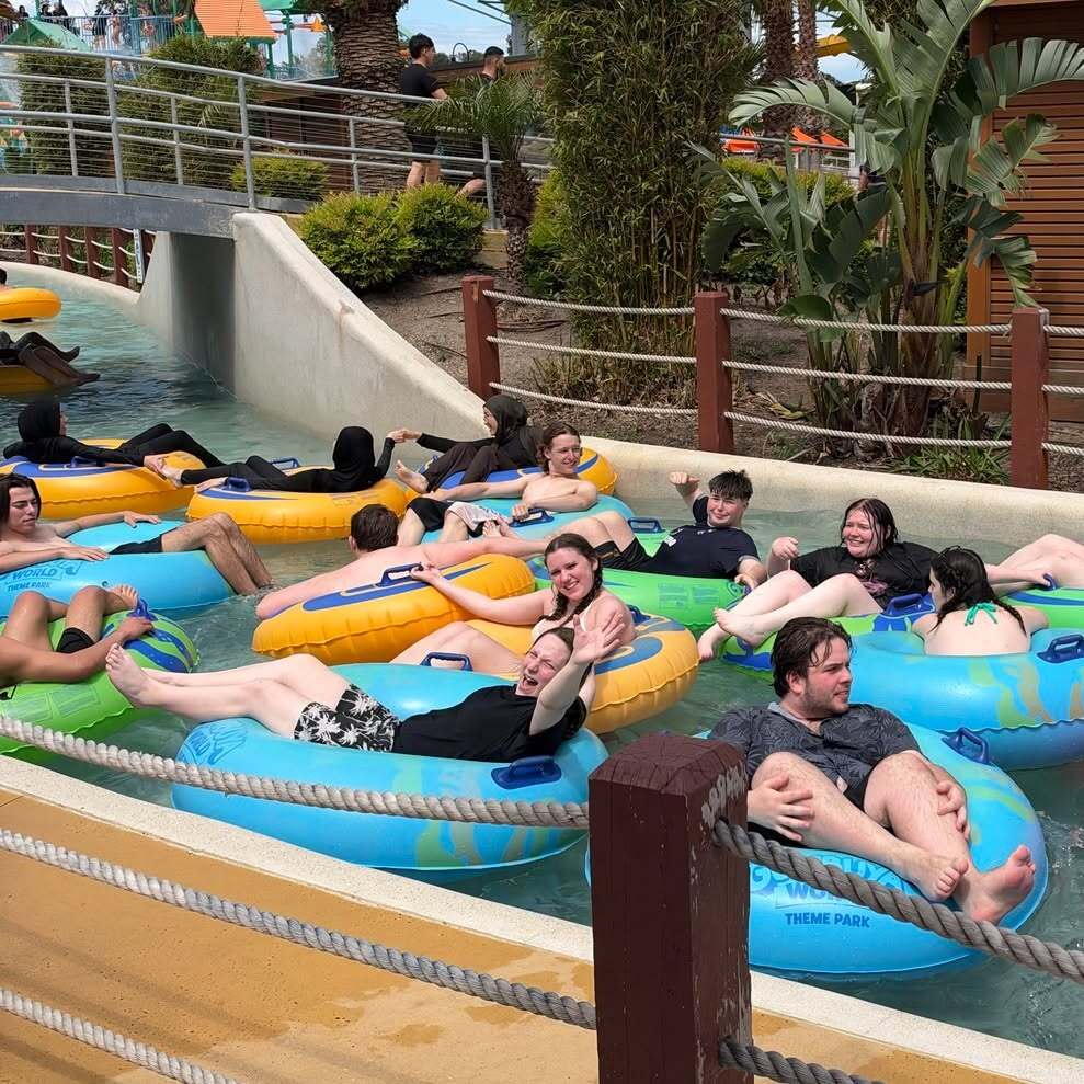 Urban College students relaxing on inflatable tubes at Gumbuya World